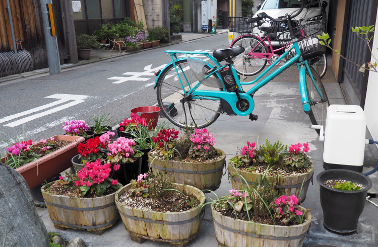 A vibrant market scene in Japan, with various food stalls and shoppers.