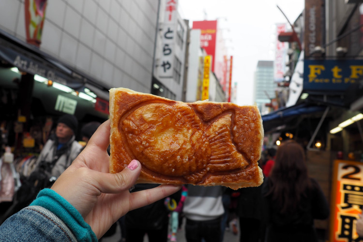 A bustling street in Tokyo, showcasing modern buildings and pedestrian traffic.