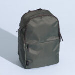 July Carry All Backpack 20L showcasing its sleek design and leather accents, perfect for modern travelers.
