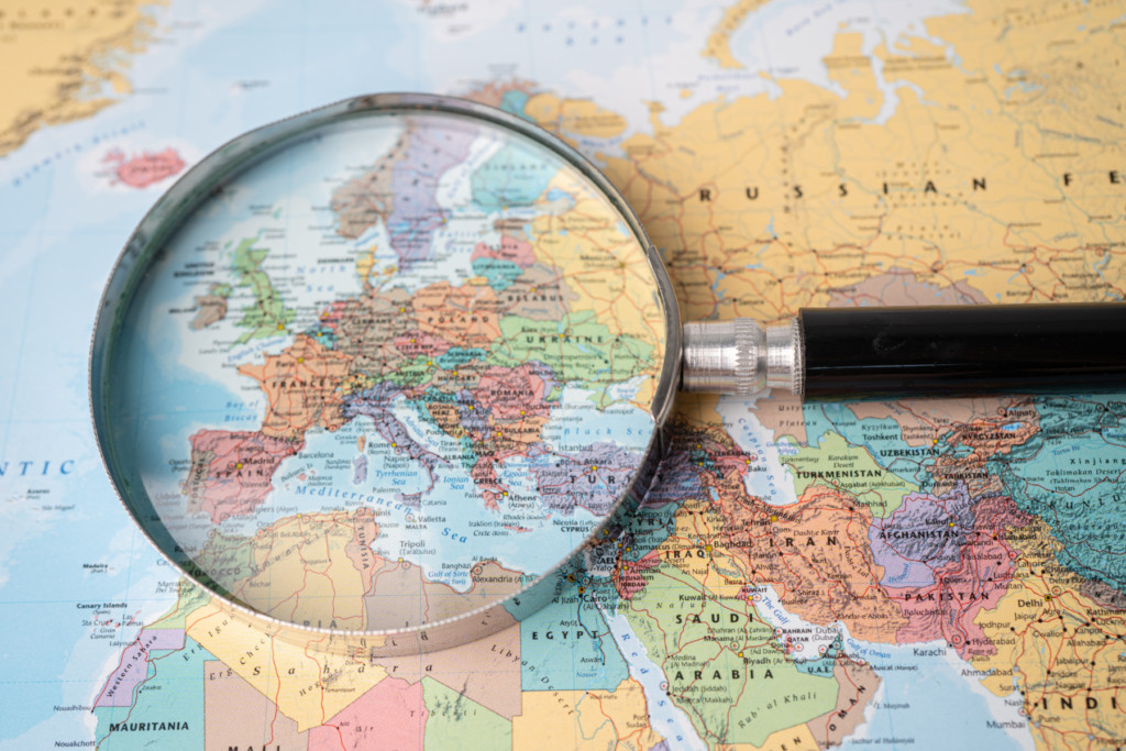 World map with magnifying glass over Europe