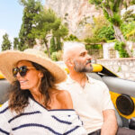 Couple enjoying an open-top car ride in Capri