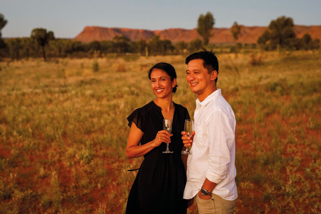 Couple watching sunset at Kings Canyon, Australia