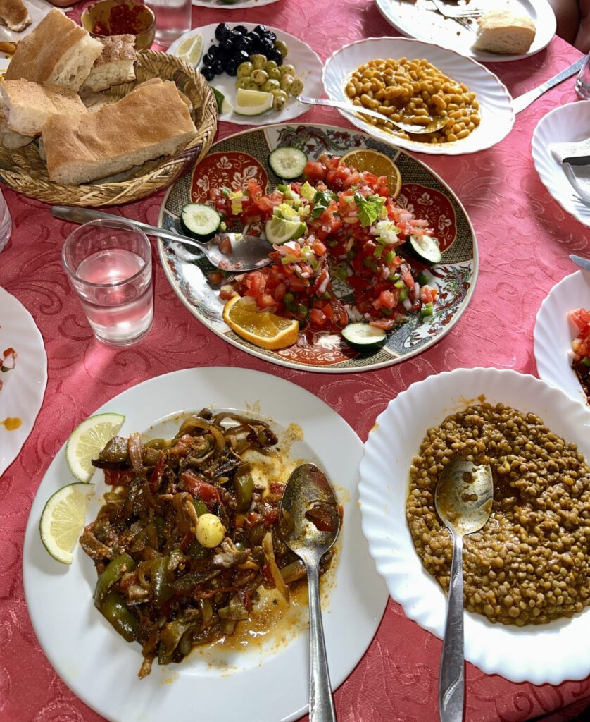 An array of Moroccan food, including beans and various types of bread, showcasing the diverse cuisine