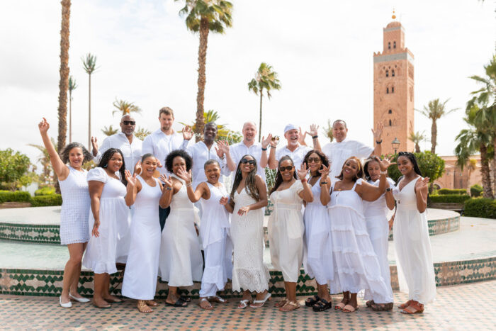 Group photo in Marrakech with the iconic Koutoubia Mosque minaret in the background
