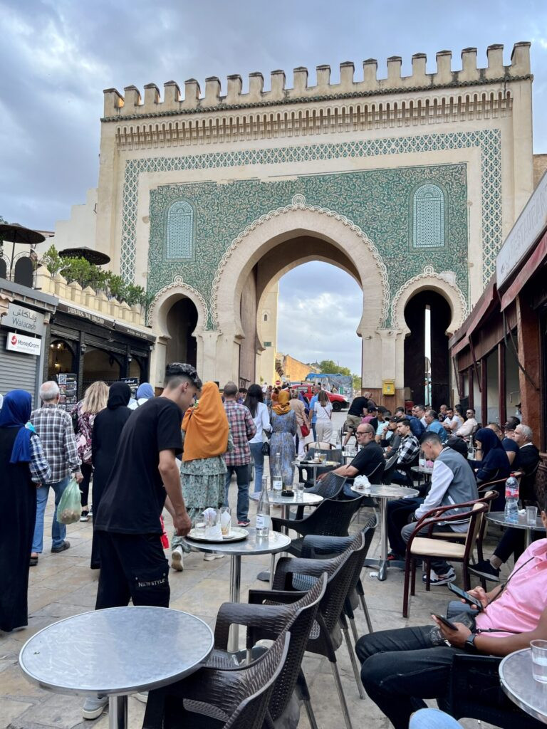 A bustling street scene within the Medina of Fes, showcasing the vibrant daily life and architecture