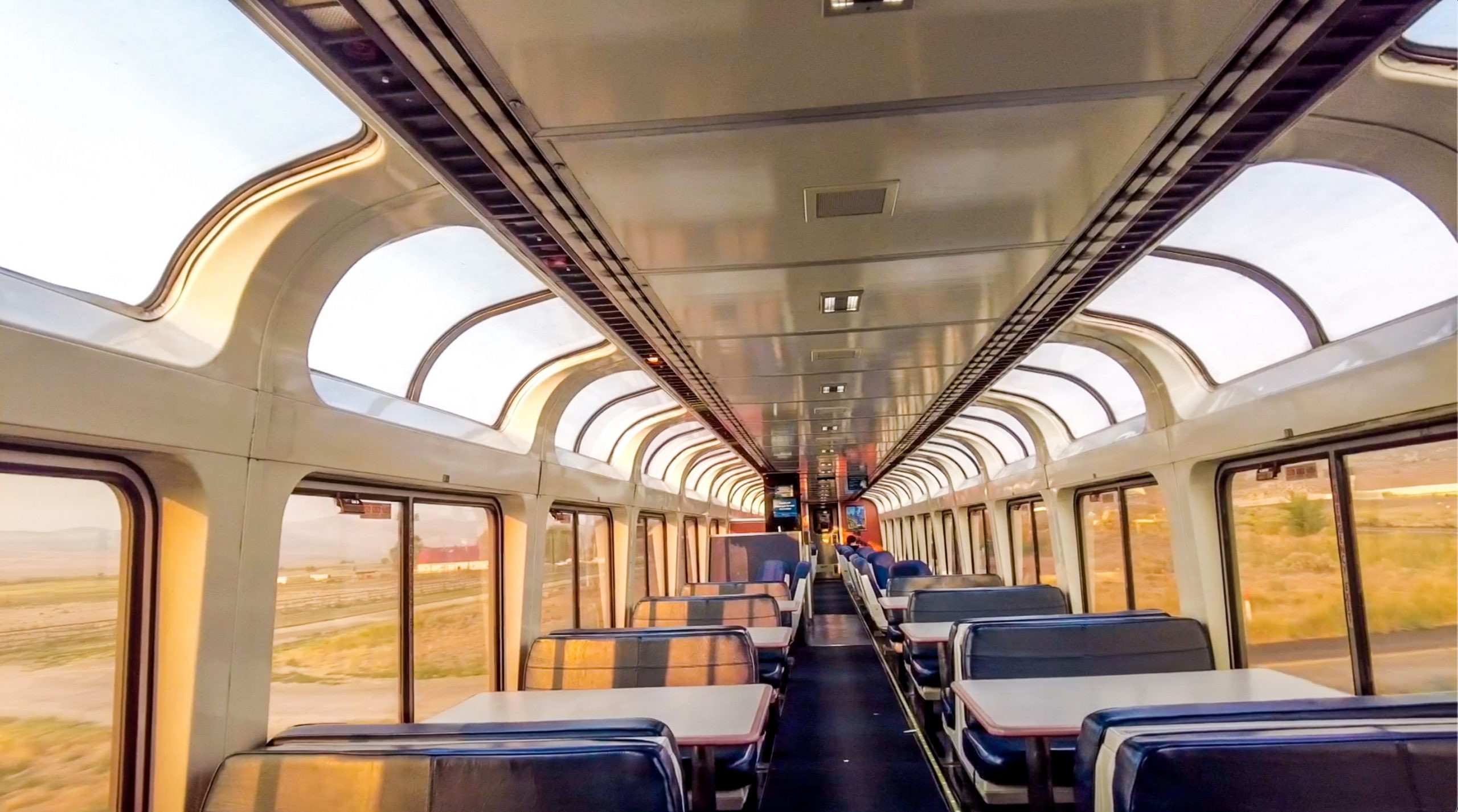 Observation car on the California Zephyr train, showcasing panoramic windows and comfortable seating.