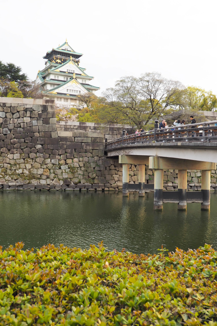 Osaka Castle, one of Japan's most famous landmarks, with cherry blossoms around it.