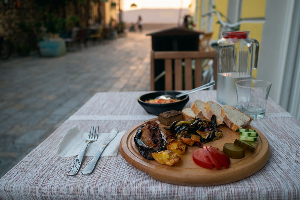 Albanian food and drinks served outdoors in a restaurant setting