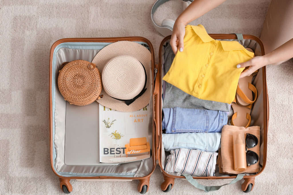 Person packing a small suitcase