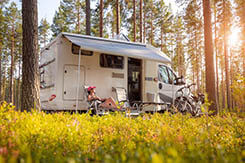 Woman relaxing outside her rented RV