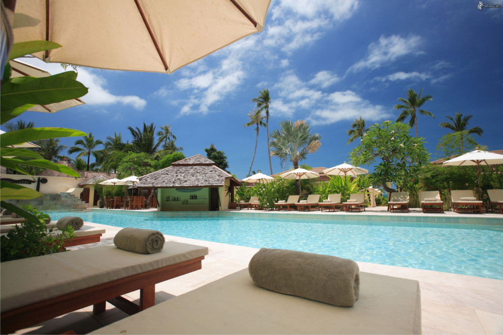 Swimming pool with sun loungers at a resort