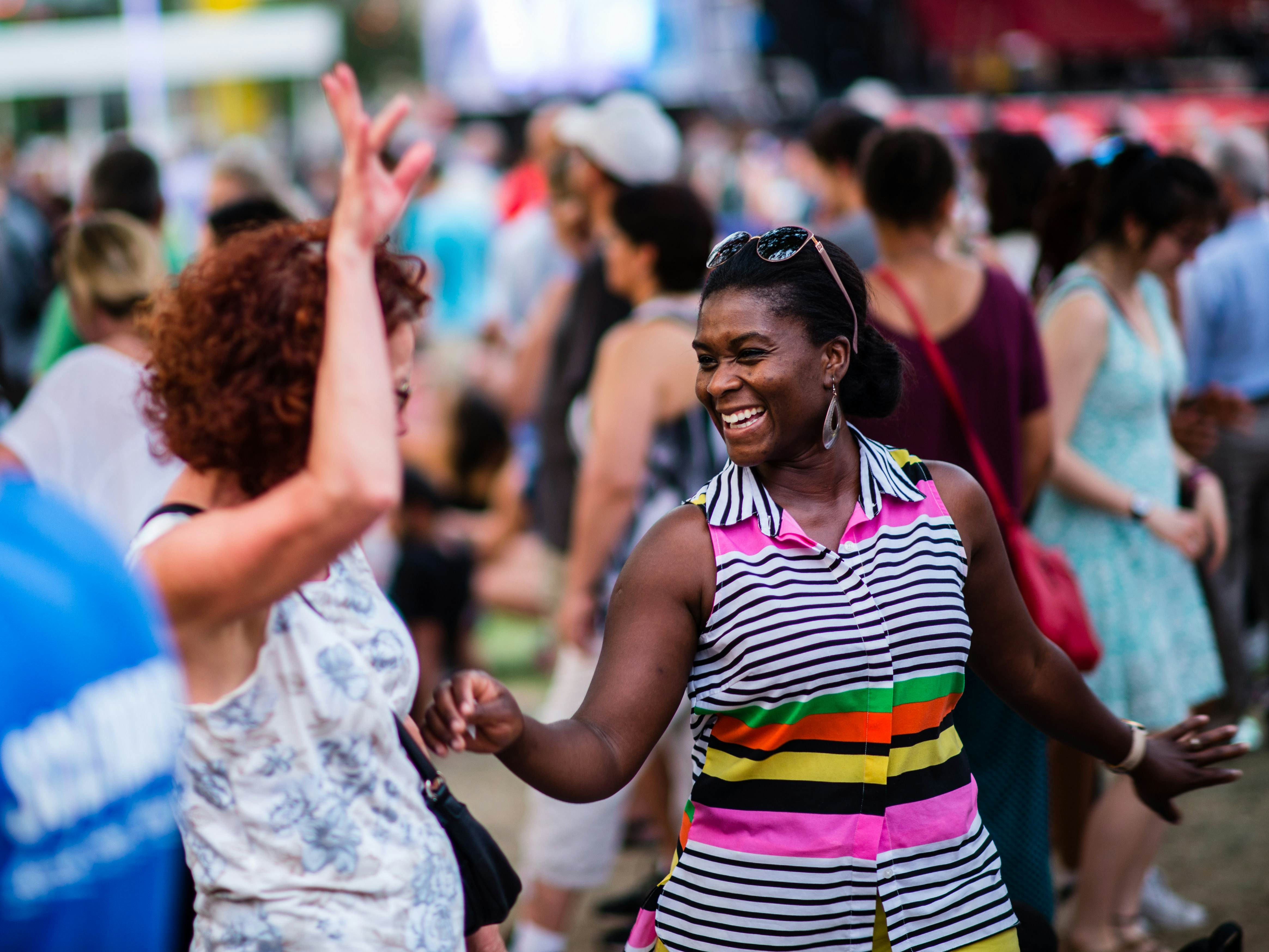 People enjoying a summer concert at Place des Arts in Montreal, capturing the city's vibrant cultural scene