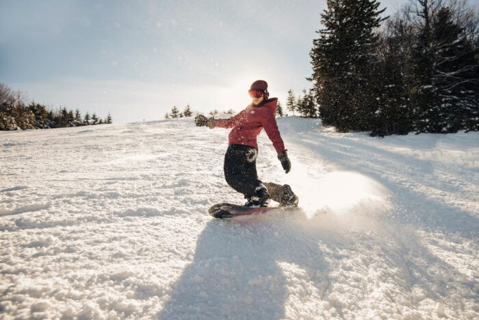 Snowboarder gliding down the slopes at Snowshoe Mountain Resort, West Virginia