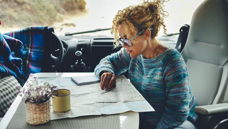 Woman confidently navigating with a map during her solo RV trip