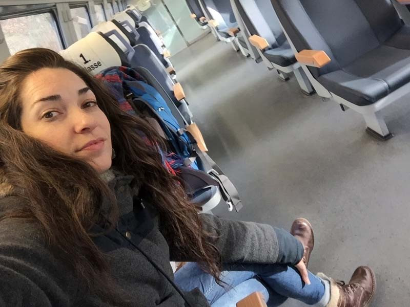 Solo backpacker on a train, representing solitude and finding home within oneself while traveling