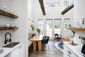 Modern cottage exterior at The Station hotel in Travelers Rest, SC with natural wood and large windows