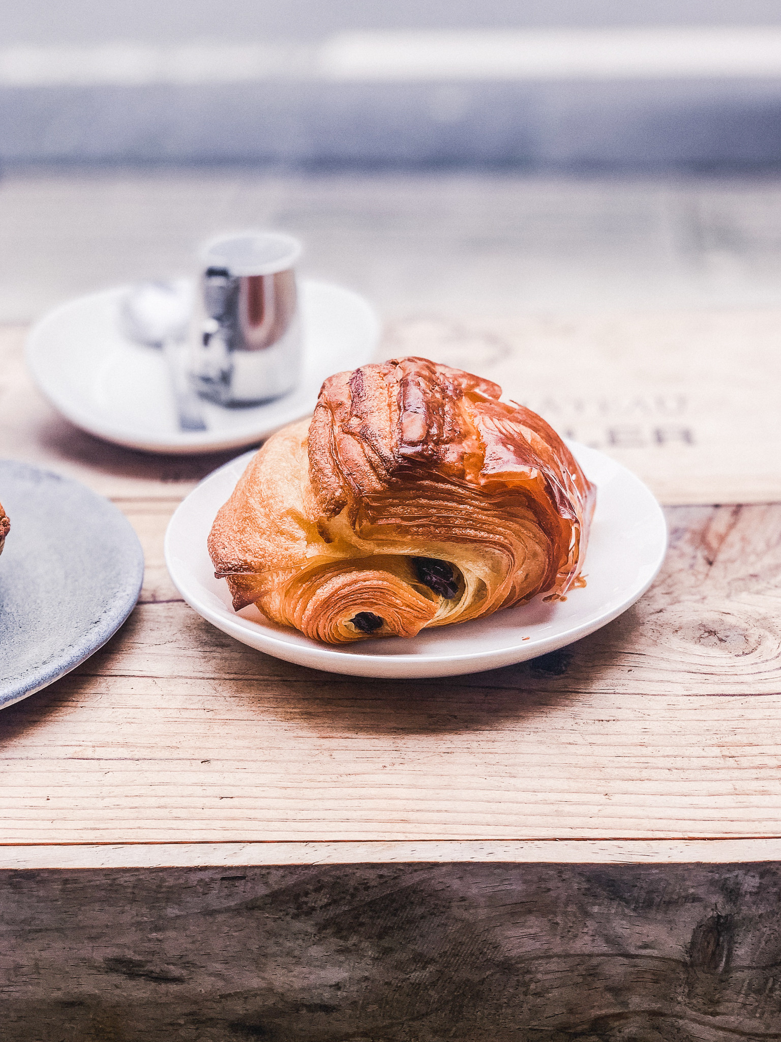 A vibrant display of freshly baked pastries, including pain au chocolat, canelés, and scones, arranged enticingly on a bakery counter, showcasing Tokyo's delightful cafe culture.