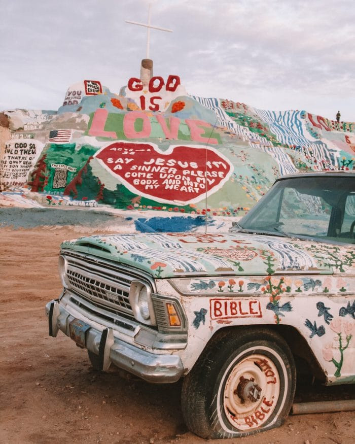 Salvation Mountain and a brightly painted car, a unique art installation in the California desert