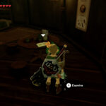 Inside South Akkala Stable, Link discovers the Super Rumor Mill EX book detailing rumors of the Travel Medallion.
