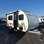 Teardrop trailer showcasing its compact size and outdoor galley, ideal for minimalist camping.