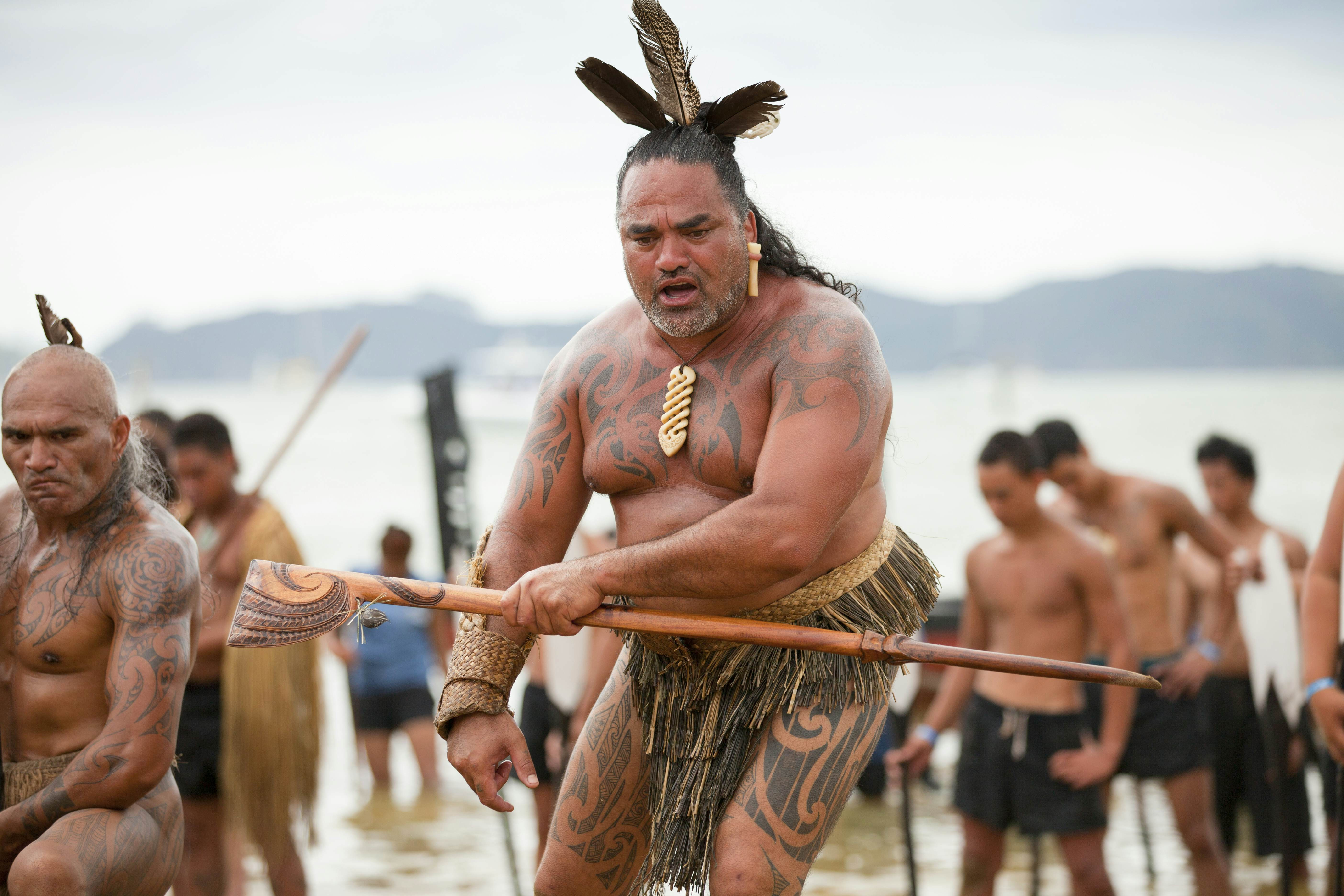 Māori warriors adorned with traditional tattoos participate in a celebration of Waitangi Day, commemorating the signing of the Treaty of Waitangi between the British Crown and Māori chiefs.