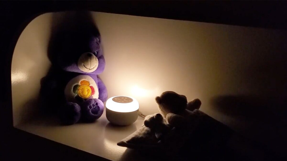 photo of the yogasleep travel mini in a bedroom with the nightlight turned on