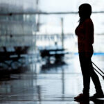 woman experiencing leg pain while traveling