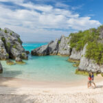Couple walking the pink sands of Horseshoe Bay, Bermuda