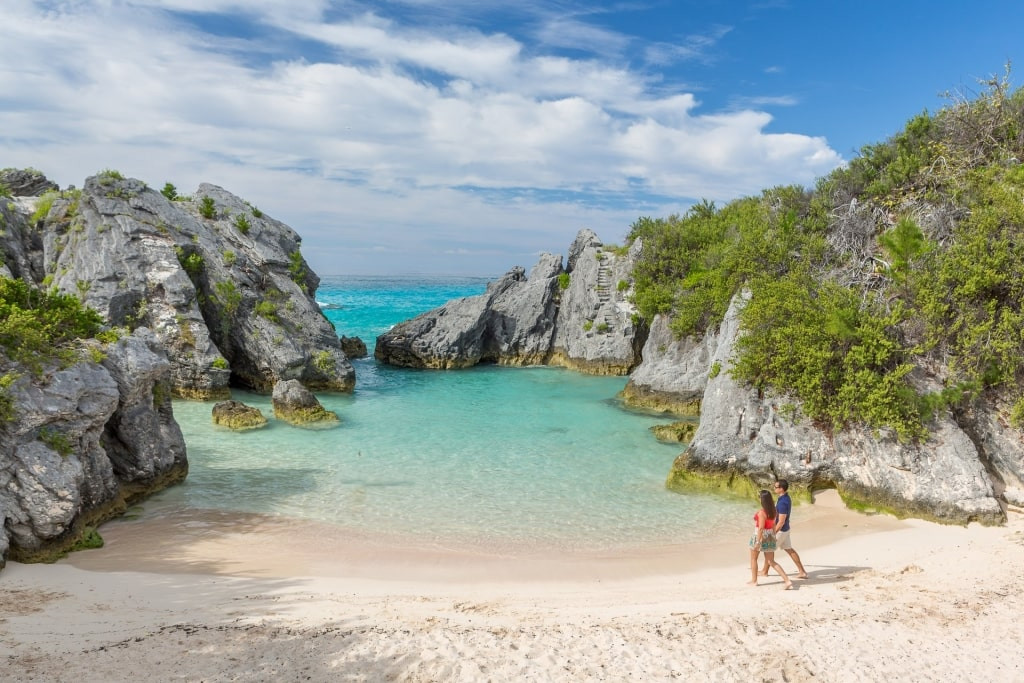 Couple walking the pink sands of Horseshoe Bay, Bermuda