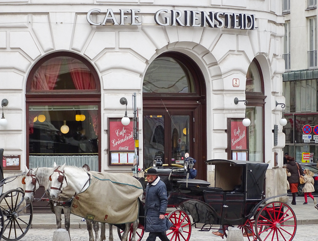 Horses and carriage outside a grand cafe in Vienna