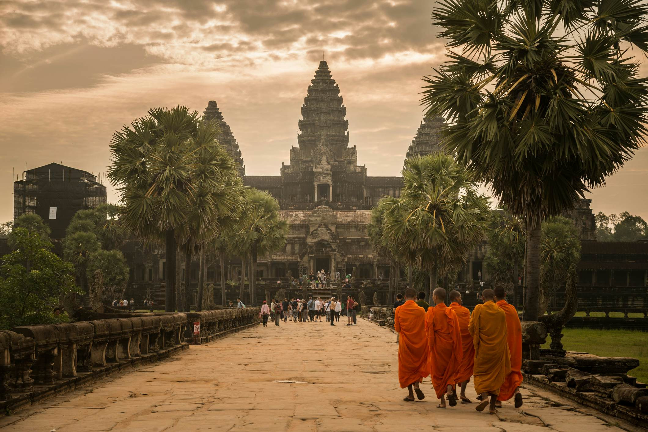 Monks walking towards an ancient temple in Angkor, Cambodia