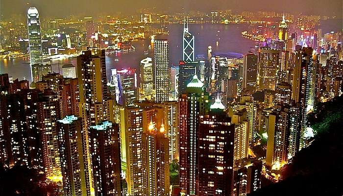 Hong Kong skyline at night, showcasing its impressive skyscrapers and vibrant city life. Explore Hong Kong's blend of Eastern and Western cultures in August.
