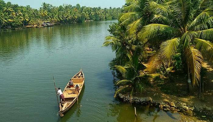 Kerala, India, showcasing its backwaters and lush greenery. Perfect for houseboat stays and water sports in Asia in August.
