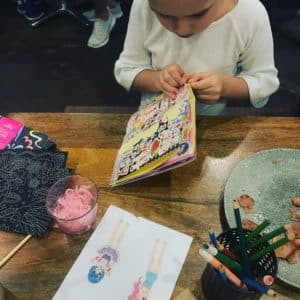 Child with coloring book in restaurant
