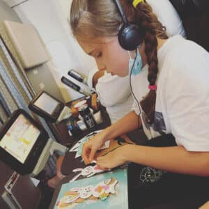 Little girl crafting on a plane