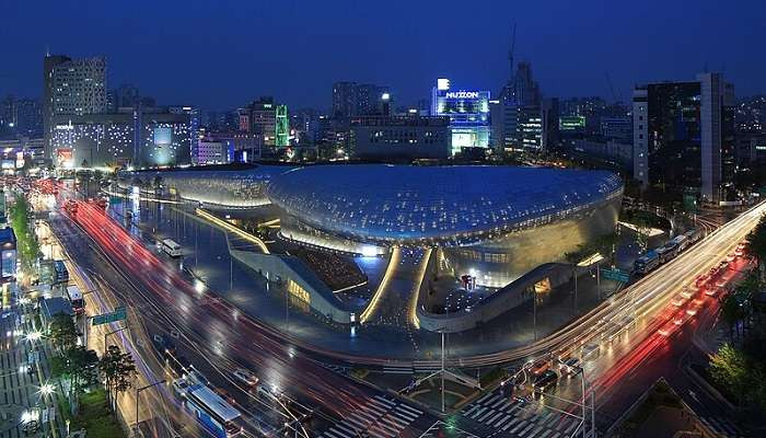 Dongdaemun Design Plaza at night in Seoul, South Korea. Experience Seoul's vibrant culture and modern architecture in August.