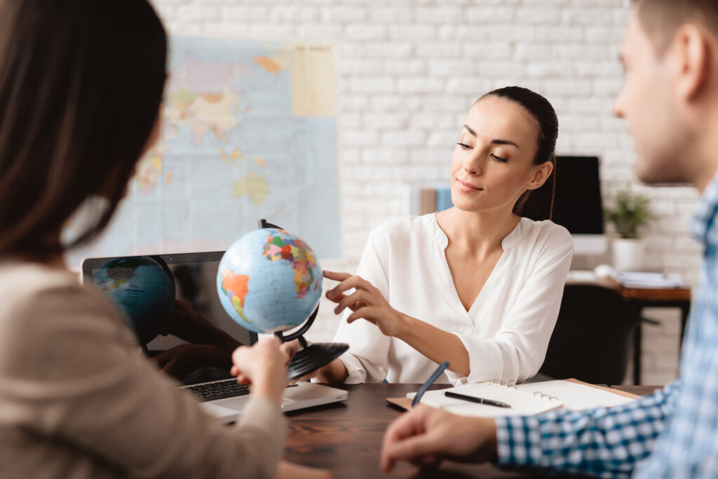 A travel advisor discussing trip options with a family, highlighting personalized service and expertise.
